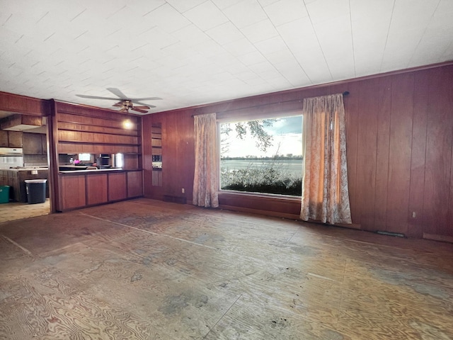 unfurnished living room featuring ceiling fan