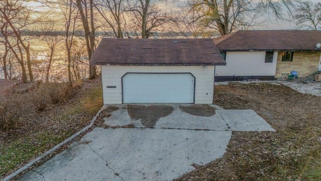 view of garage at dusk