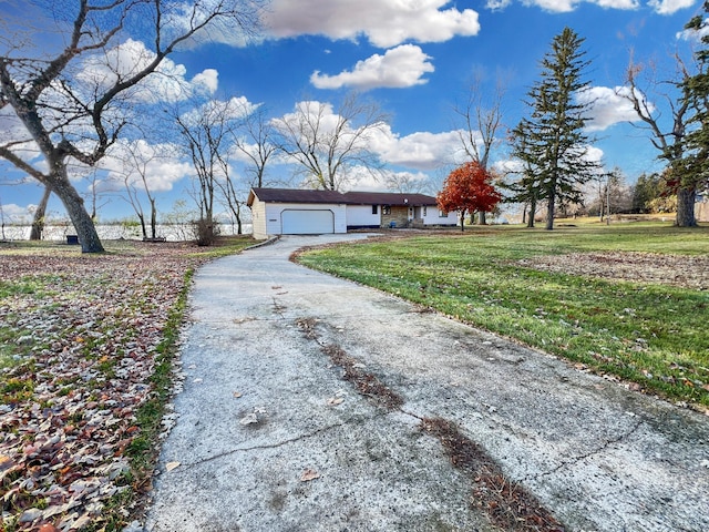 single story home featuring a garage and a front lawn