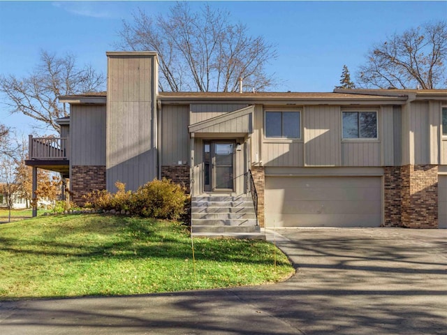 view of front of house with a front yard and a garage