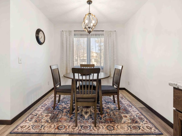 dining room with a chandelier and light wood-type flooring