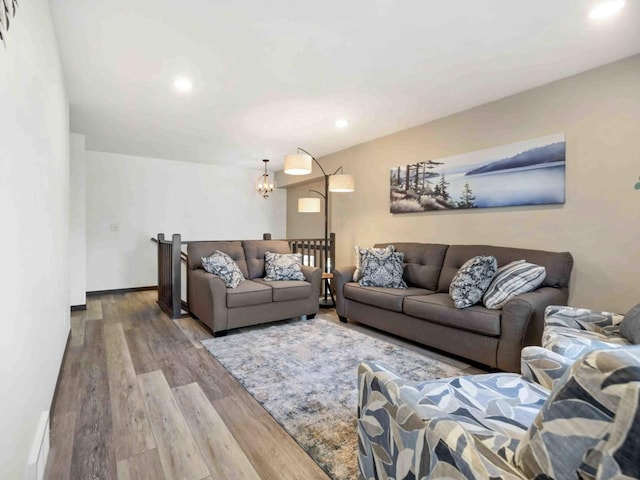 living room featuring hardwood / wood-style floors and an inviting chandelier