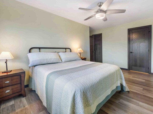 bedroom with ceiling fan and wood-type flooring