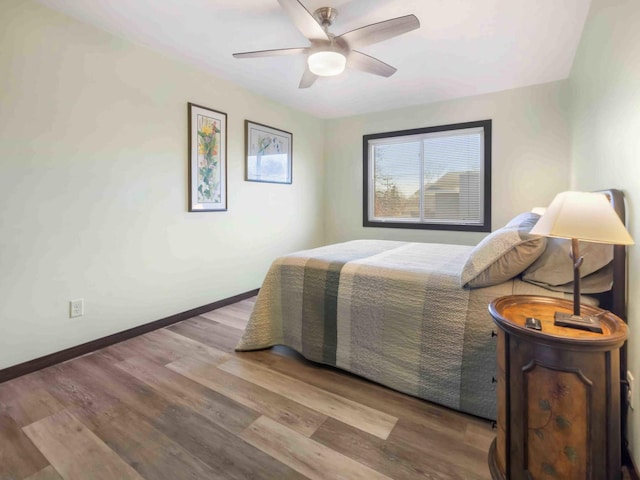 bedroom with ceiling fan and light wood-type flooring