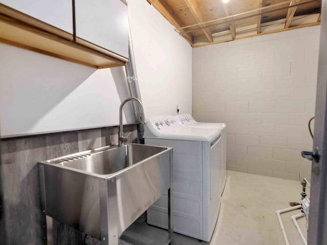 washroom with washing machine and clothes dryer and sink