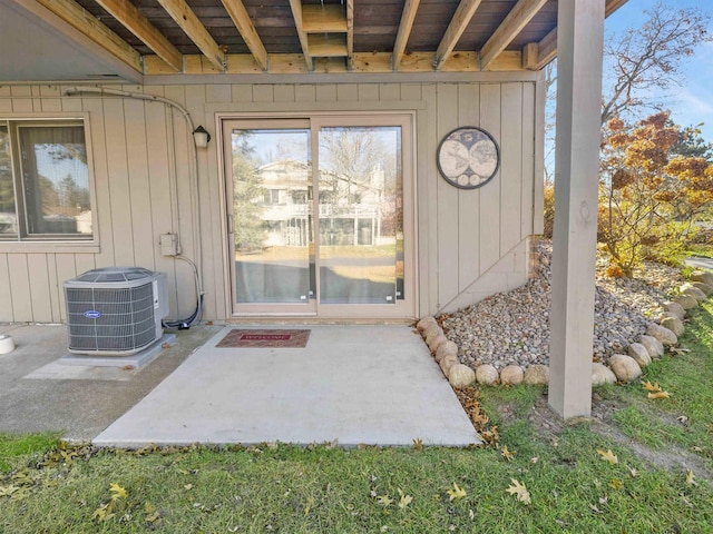 doorway to property featuring a patio and central AC