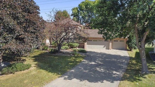 view of property hidden behind natural elements with a garage and a front yard