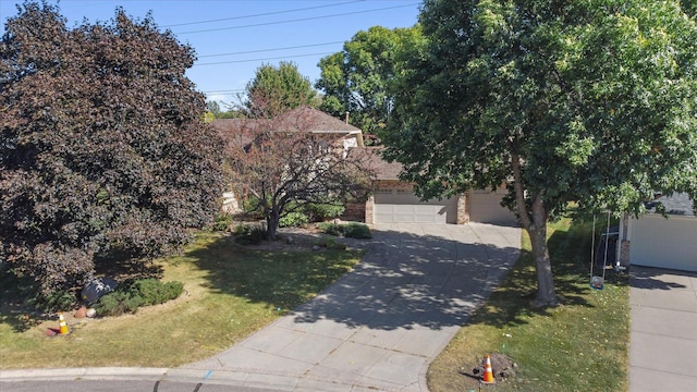 obstructed view of property featuring a garage and a front lawn