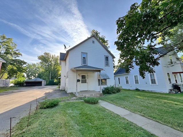 717 Jefferson Ave, Albert Lea, MN 56007 - view of front of house featuring a front lawn and an outbuilding
