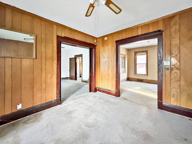717 Jefferson Ave, Albert Lea, MN 56007 - unfurnished room featuring baseboards, a ceiling fan, and wooden walls