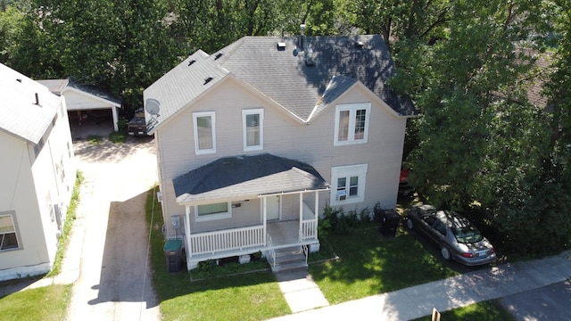 exterior space with a porch and a front yard