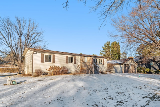 single story home with an outbuilding and a garage