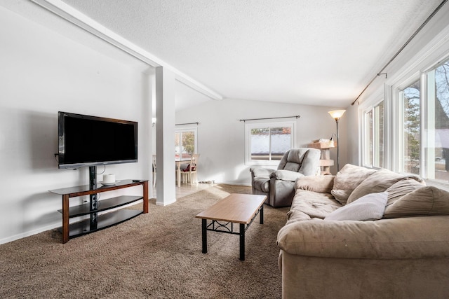 carpeted living room featuring lofted ceiling with beams and a textured ceiling