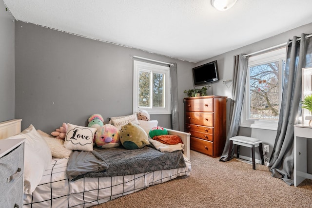 bedroom featuring multiple windows and light carpet