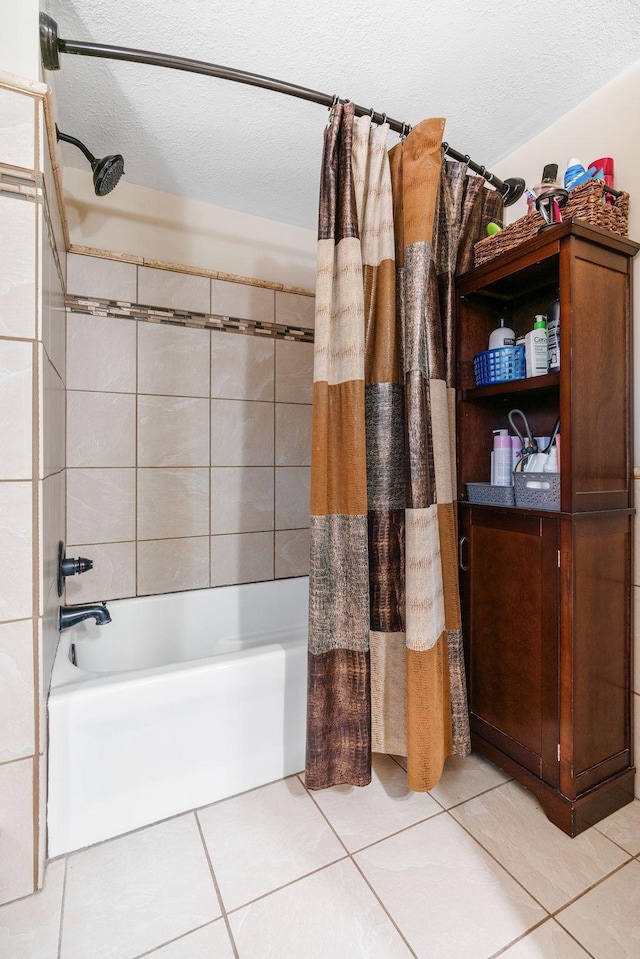 bathroom featuring tile patterned flooring, a textured ceiling, and shower / bath combo with shower curtain