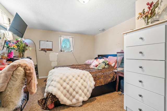 bedroom featuring light carpet and a textured ceiling