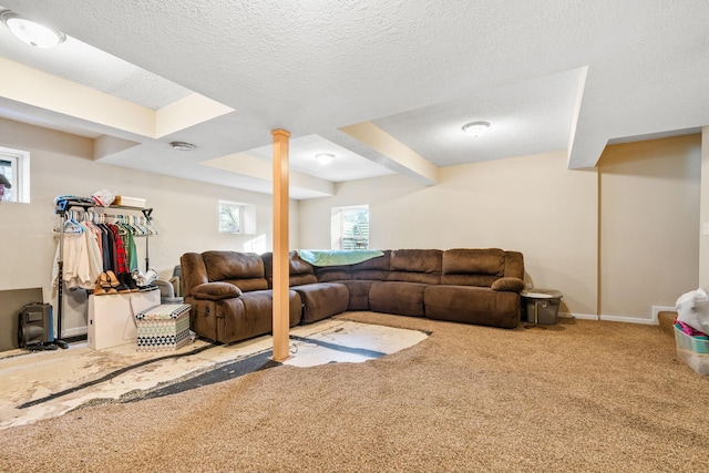 carpeted living room featuring a textured ceiling