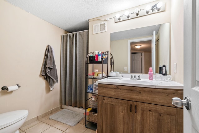 bathroom with tile patterned floors, toilet, a textured ceiling, vanity, and a shower with shower curtain