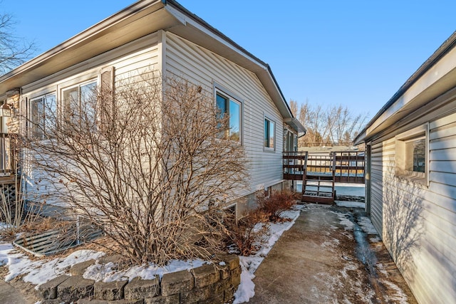 view of side of property featuring a wooden deck