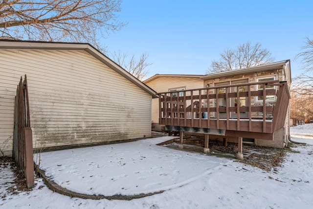 view of snowy exterior featuring a deck