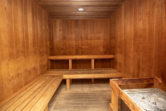 view of sauna / steam room featuring wood walls, wood ceiling, and hardwood / wood-style floors