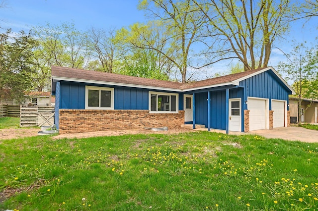 ranch-style house featuring a front yard and a garage