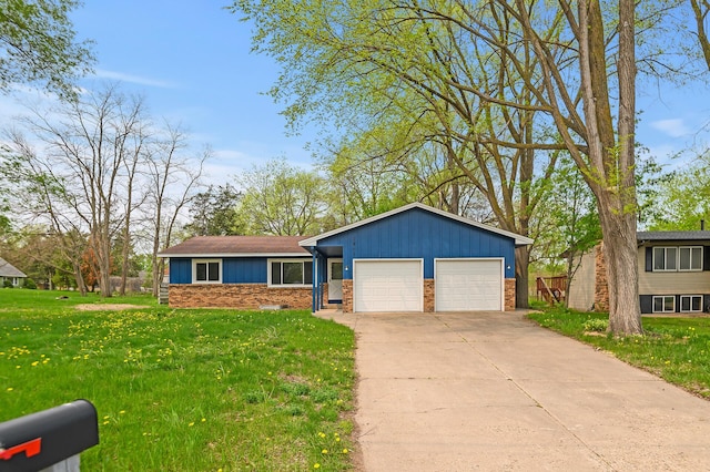 ranch-style house featuring a garage and a front lawn