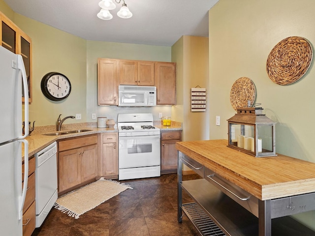 kitchen featuring sink, white appliances, a notable chandelier, and light brown cabinets