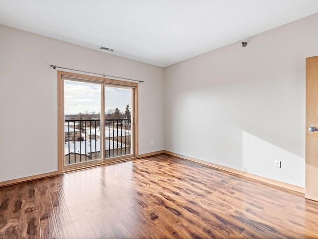 unfurnished room with hardwood / wood-style floors