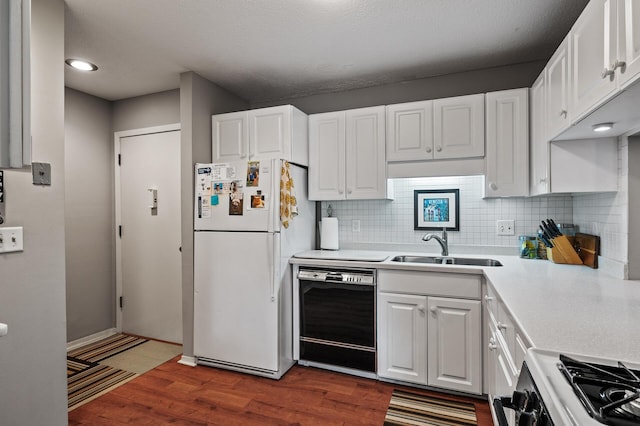 kitchen with range with gas cooktop, white refrigerator, dishwasher, dark hardwood / wood-style floors, and white cabinetry