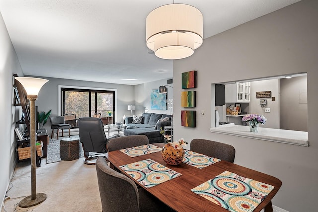 view of carpeted dining area