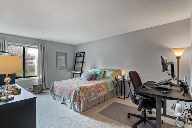 bedroom featuring baseboard heating and light carpet