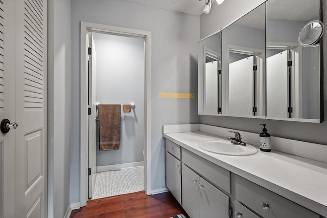 bathroom featuring vanity, a textured ceiling, and hardwood / wood-style flooring