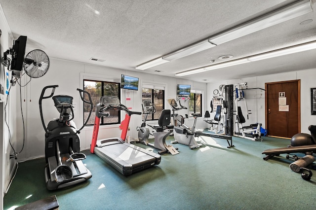 workout area featuring a textured ceiling