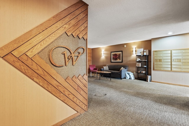 interior space with carpet flooring, mail boxes, and a textured ceiling