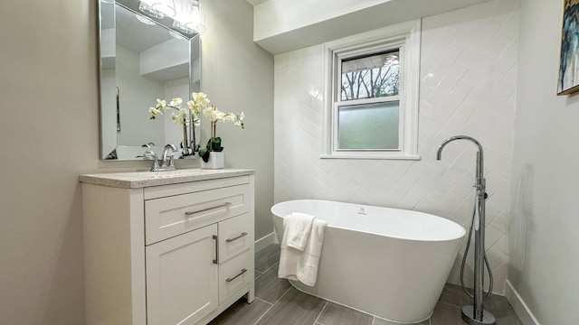 bathroom featuring a washtub, hardwood / wood-style floors, and vanity