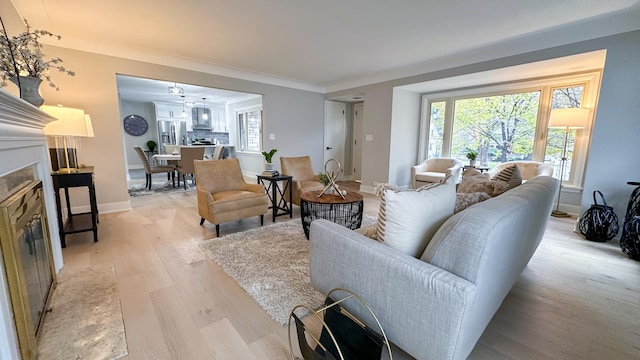 living room with light hardwood / wood-style flooring and ornamental molding