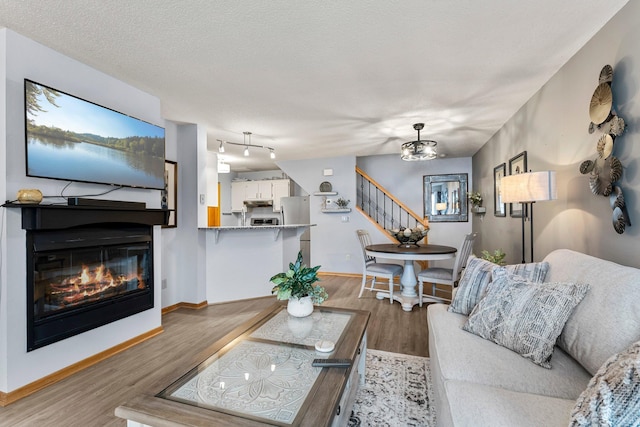 living room featuring a textured ceiling and hardwood / wood-style flooring