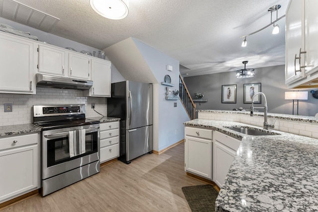 kitchen with white cabinetry, pendant lighting, sink, and stainless steel appliances