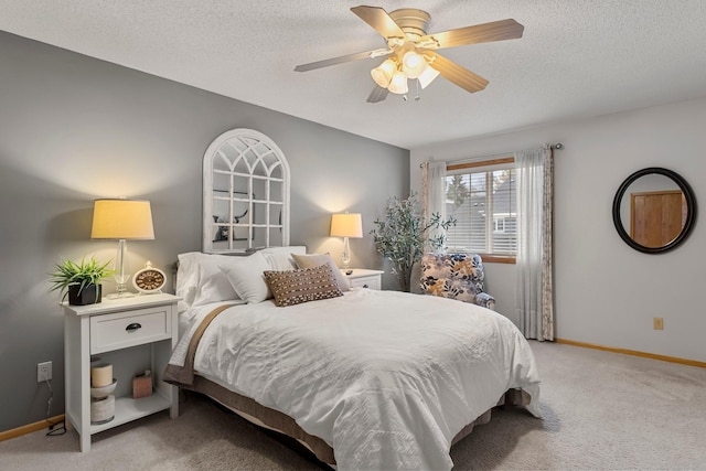 bedroom featuring ceiling fan, a textured ceiling, and light carpet