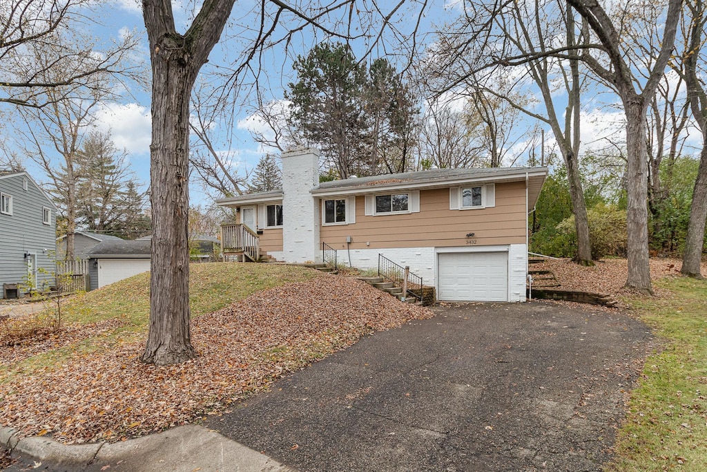3432 Yukon Ave S, Saint Louis Park, MN 55426 - ranch-style home featuring driveway, an attached garage, and a chimney
