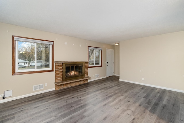 unfurnished living room with a fireplace and hardwood / wood-style floors