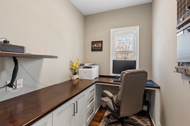 home office with dark hardwood / wood-style flooring