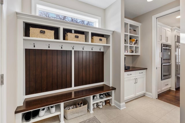 mudroom featuring a wealth of natural light and light tile patterned floors