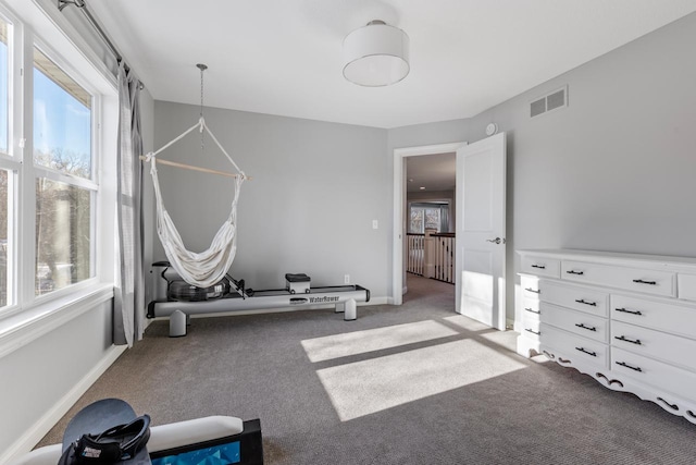 exercise room with light colored carpet