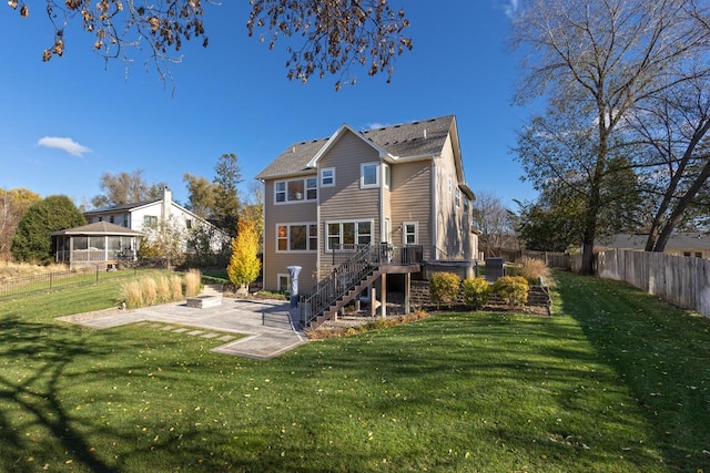 rear view of property featuring a patio area and a lawn