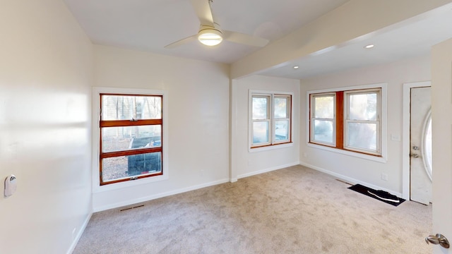 carpeted foyer featuring ceiling fan