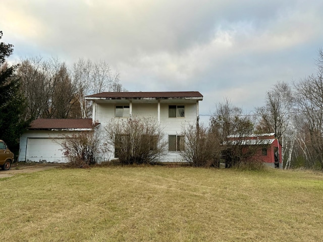 view of front facade with a garage, a front lawn, and an outdoor structure