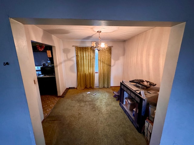 misc room featuring carpet flooring and a chandelier