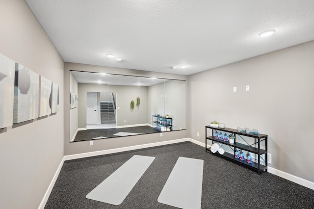 exercise room with a textured ceiling